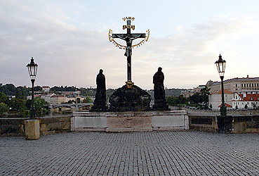 Prague's Charles Bridge just after dawn. This setting is one of the highlights of the  many statues scattered along the sides of the bridge — they are on either side of you as walk across.  In 2000, Candy got pictures of every single one while fending off foreign men trying to score with the American chick.  (2003)