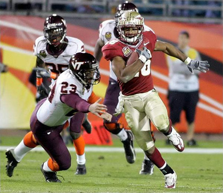 FSU's Willie Reid escapes Virginia Tech defenders in the midst of his 83-yard punt return for a touchdown in the third quarter of the inaugural ACC Championship game in Jacksonville.  Photo by Mark Wallheiser for the Tallahassee Democrat.  (2005)