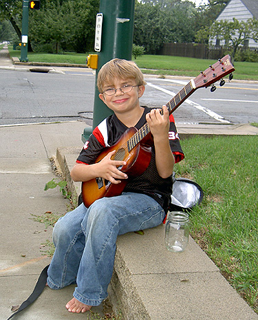 My nephew Alex playing street musician in his neighborhood last summer. (2005)
