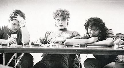 Found in my 1987 Anumpa, AKA The Rickards High Yearbook.  This picture is taken from one of the many Brain Brawl matches in which I competed.  Caption reads:
INTENSE — Ed (Costello), Peter (Lakanen) and Angela (Romans) listen while the judge explains a ruling during their match with Leon[Disclaimer: I added last names and, no, I don't know who's hand that is on the right.]