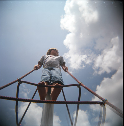 Alex atop the rope pyramid at Tom Brown Park.  He's at least 15 feet off the ground.  (2007)