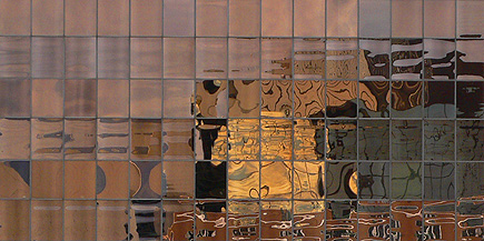 Cropped version of the image of one building reflected (all wavy and stuff) in the mirrored side of another building in Anchorage.  (2007)