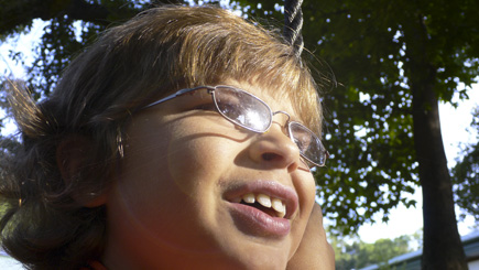Close-up of The Alex on his favorite swing at the Cornerstone Learning Community, where he's been attending Pottery Camp.  Slight lens flare added with Photoshop.  (2008)