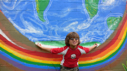Nephew Alex plays Titan with a mural on Gaines Street.  (2008)