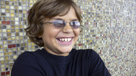 Alex caught in mid-laugh in front of the new tile wall outside New Leaf Market.  (2008)