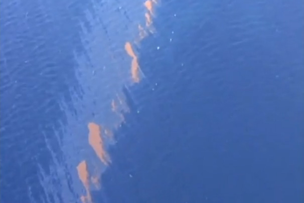 Screenshot from video shot from an airplane flying over the oil spill in the Gulf of Mexico.  Each of those pink blobs is all crude and about the size of a football field.  (2010)